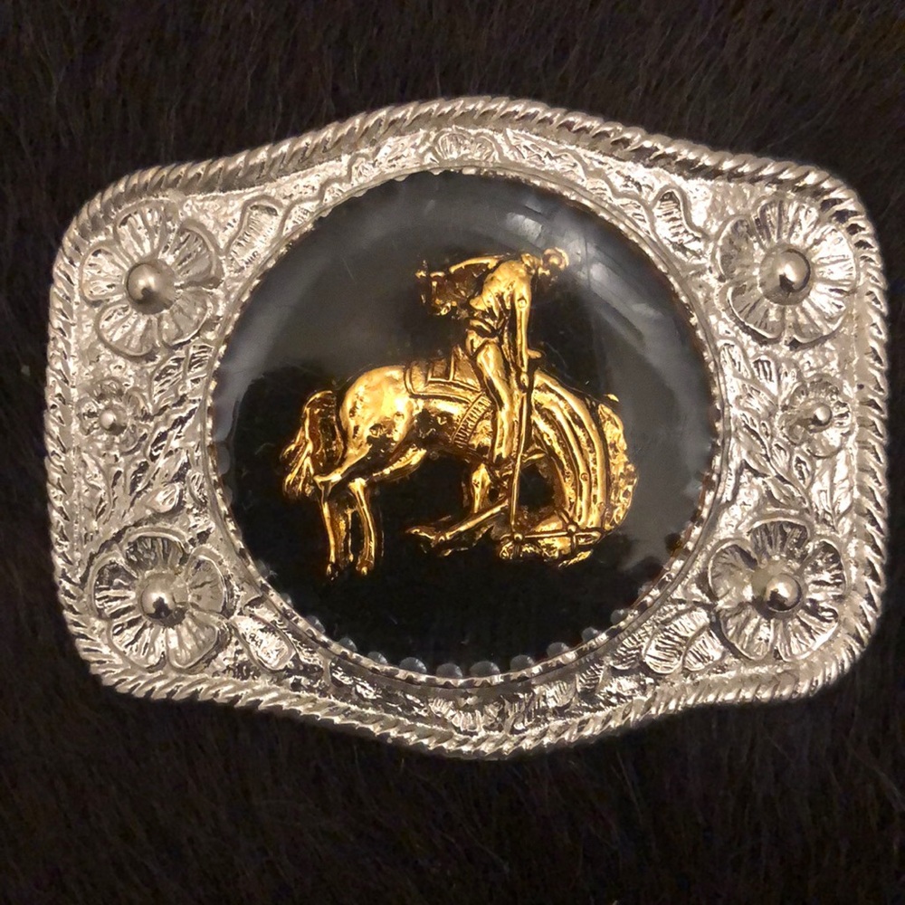 Vintage western belt buckle with a gold tone bucking horse